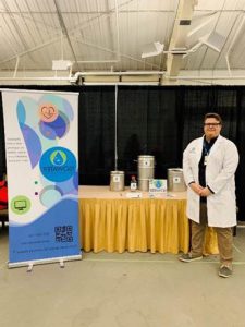 Deuterium scientist at a display booth for exhibiting career opportunities for Isowater Deuterium Oxide Supply and Delivery